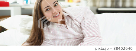 Brunette girl laying in bed Brunette girl laying in bed 88402640