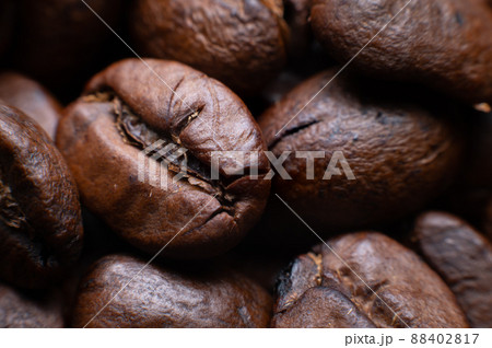 Close up extreme macro group of roasted brown or black coffee beans background in shallow depth of field. Enchanting coffee aroma Close up extreme macro group of roasted brown or black coffee beans background in shallow depth of field. Enchanting coffee aroma 88402817