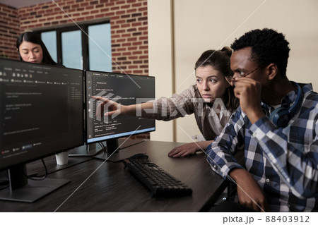 Caucasian software developer signaling on screen data breach and deactivated security system. Tech engineer observing multiple system security breaches caused by overloaded storage servers. Caucasian software developer signaling on screen data breach and deactivated security system. Tech engineer observing multiple system security breaches caused by overloaded storage servers. 88403912