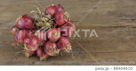 Premium Photo  Thai spicy herb shallot bunch of shallots with root on  wooden table and space on right