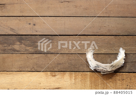 Edible swiftlet nest on brown wooden , raw edible bird's nest materials before remove feather for tradition chinese medicine. 88405015