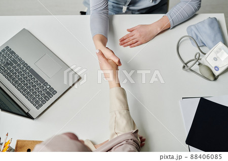 Above angle of handshake of Muslim female patient and young clinician Above angle of handshake of Muslim female patient and young clinician 88406085