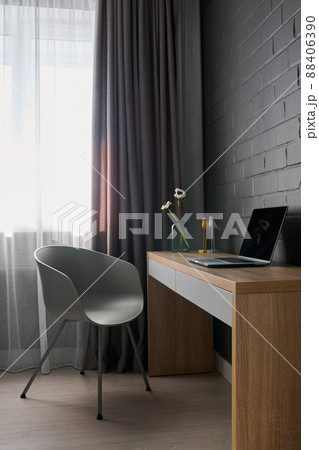 Part of spacious living room or bedroom with workplace in the corner 88406390