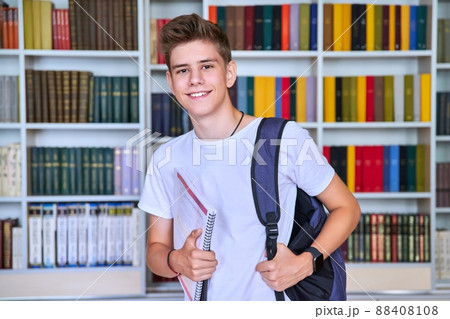 Portrait of male teenage student looking into the camera in library Portrait of male teenage student looking into the camera in library 88408108
