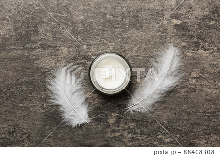 Spa cosmetic product, cream jar, branding mock up, top view with feathers background. Flat lay Spa cosmetic product, cream jar, branding mock up, top view with feathers background. Flat lay 88408308