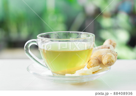 Closeup Fresh ginger with sliced and hot ginger glass on white white table, herb and medical for health concept 88408936