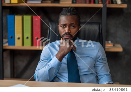 Low-spirited male entrepreneur sitting in his office 88410861