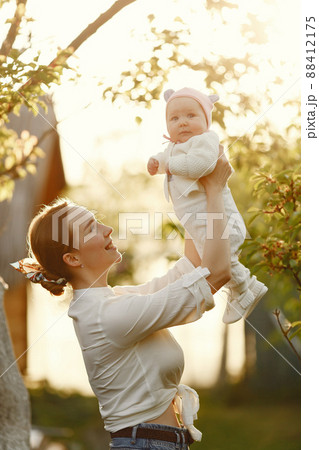 Mother with daughter. Family in a park. Newborn girl. 88412175