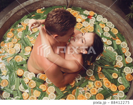 Couple in a bath. People on a Bali. Bath with fruits. Couple in a bath. People on a Bali. Bath with fruits. 88412275