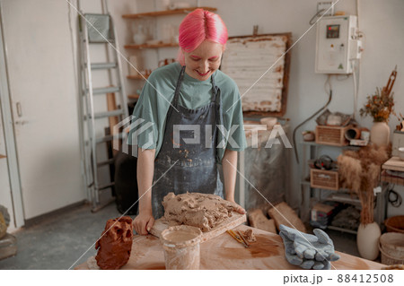 Young ceramist working with clay in workroom Young ceramist working with clay in workroom 88412508