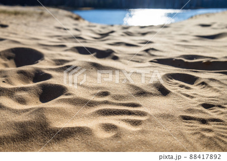 Sand at the beach with a human footprint steps 88417892