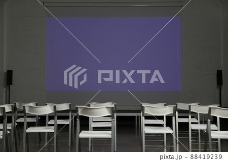 Empty conference room with projection screen and chairs Empty conference room with projection screen and chairs 88419239