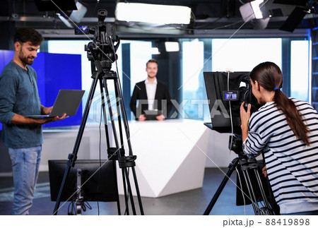 Presenter, director and video camera operator working in studio. News broadcasting Presenter, director and video camera operator working in studio. News broadcasting 88419898