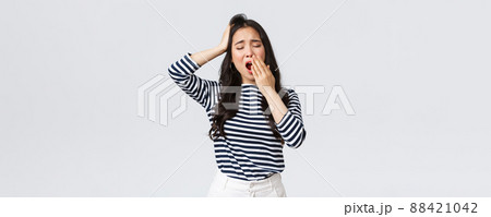 Lifestyle, people emotions and casual concept. Sleepy tired woman working late in office, close eyes and yawning, want go bad. Asian girl woke up early, need coffee, stand white background Lifestyle, people emotions and casual concept. Sleepy tired woman working late in office, close eyes and yawning, want go bad. Asian girl woke up early, need coffee, stand white background 88421042