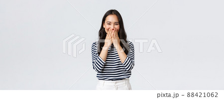 Lifestyle, people emotions and casual concept. Cute silly asian female giggle while gossiping and mocking someone, cover mouth as smiling and laughing carefree Lifestyle, people emotions and casual concept. Cute silly asian female giggle while gossiping and mocking someone, cover mouth as smiling and laughing carefree 88421062