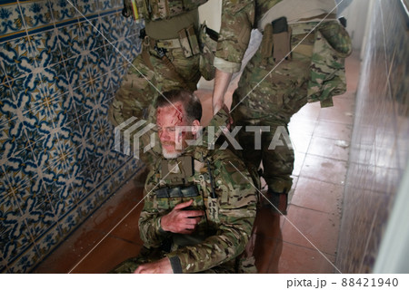 Strong military men helping wounded friend Strong military men helping wounded friend 88421940