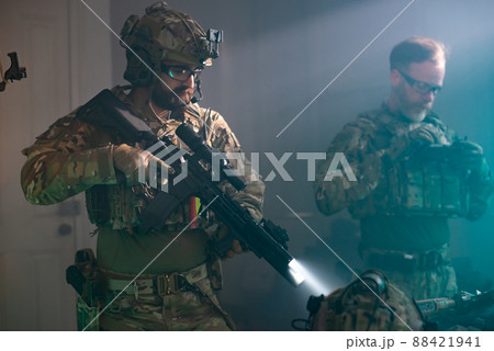 Men in military equipment in dark room Men in military equipment in dark room 88421941