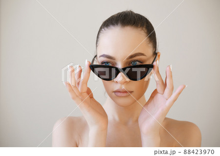 Woman face in sunglasses. Girl face close up portrait of woman. Young girl 88423970