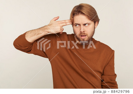 Portrait of emotional bearded man on gray background. 88429796