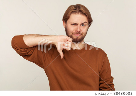 Portrait of emotional bearded man on gray background. 88430003