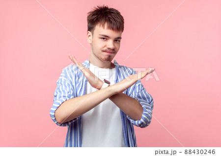 There is no way. Portrait of disappointed young brown-haired man with small beard and mustache in casual shirt crossing hands, warning with end gesture. indoor studio shot isolated on pink background 88430246