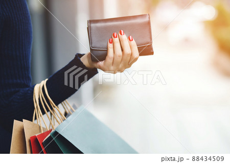 woman person holding a wallet in the hand. Cost control expenses shopping in concept. Leave space to write descriptive text. woman person holding a wallet in the hand. Cost control expenses shopping in concept. Leave space to write descriptive text. 88434509