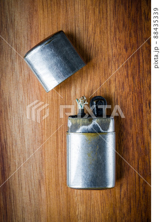 Old vintage lighter on a wooden background 88435339