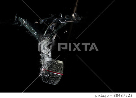 Microphone underwater - sinking mic. Professional microphone in water - concept. Microphone underwater - sinking mic. Professional microphone in water - concept. 88437523