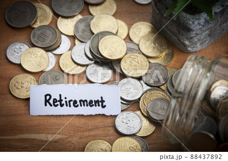 Retirement text on torn paper with coins and wooden table background. Retirement text on torn paper with coins and wooden table background. 88437892