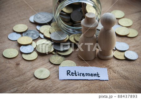 Retirement text on torn paper with coins and wooden dolls model background. Retirement text on torn paper with coins and wooden dolls model background. 88437893