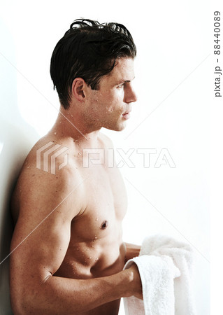 Chiseled perfection. Side view of a handsome young man holding a towel. Chiseled perfection. Side view of a handsome young man holding a towel. 88440089