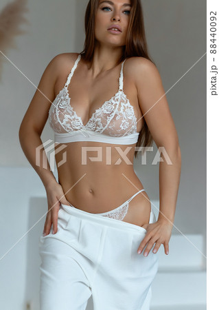 Seductive female taking off pajama pants 88440092