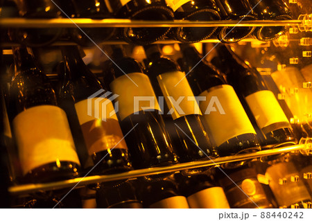 Closeup shot of wineshelf, vine. Bottles on the wall - wine. Closeup shot of wineshelf, vine. Bottles on the wall - wine. 88440242