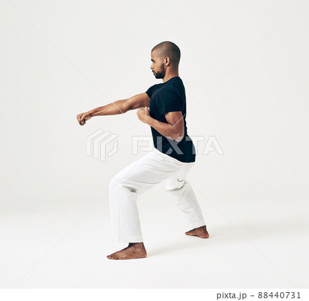 Learning is a gift even if pain is your teacher. Studio shot of a young martial artist practicing. Learning is a gift even if pain is your teacher. Studio shot of a young martial artist practicing. 88440731