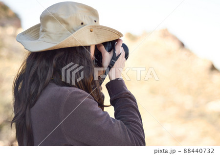 Capturing the wild. A young woman taking pictures outside. Capturing the wild. A young woman taking pictures outside. 88440732