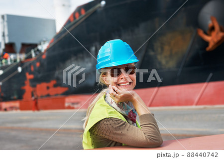 My attitude is never to be satisfied. A confident young woman resting her chin on her hands next to a ship.. 88440742