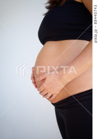 I cant wait to hold my child. Expectant mother holding her pregnant belly - Cropped. I cant wait to hold my child. Expectant mother holding her pregnant belly - Cropped. 88440743