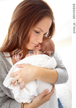 My precious little baby. Shot of a young mother holding her newborn baby girl in her arms. 88440808