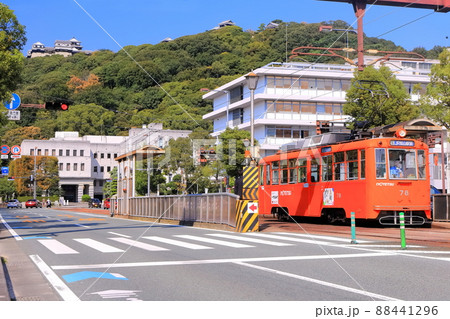 【愛媛県】松山市役所前から見た秋の松山城と伊予鉄電車 88441296