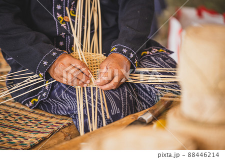 Asian hilltribe woman handcraft weaving bamboo stripe for basket or tray. Asian hilltribe woman handcraft weaving bamboo stripe for basket or tray. 88446214