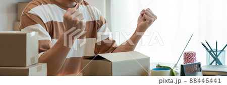 Online shopping concept the online salesperson having cheerful facial expression while setting his goods into the box 88446441