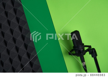 Microphone on red background with copy space and acoustic foam panel 88446983