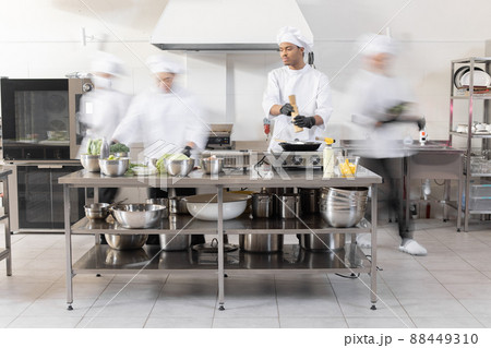 Chef cooks working in professional kitchen 88449310
