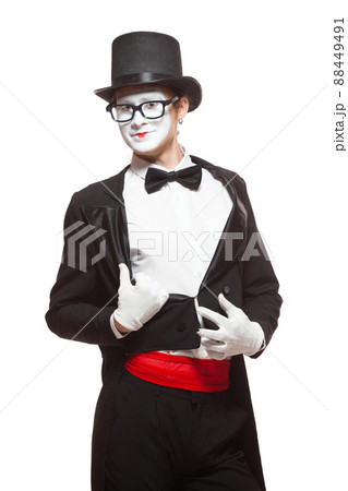 Portrait of a male mime artist performing, isolated on white background. He takes off his jacket. Symbol of seduction, charm, flirting Portrait of a male mime artist performing, isolated on white background. He takes off his jacket. Symbol of seduction, charm, flirting 88449491