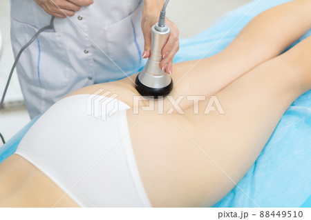 Close up shot of a relaxed woman getting RF lifting endospheres therapy massage at spa center. Due to the deep heating of muscle tissues, a fast and stable lifting effect is achieved, the process of 88449510