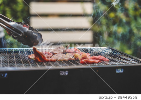 Close up of grilling meat on the charcoal grill. 88449558