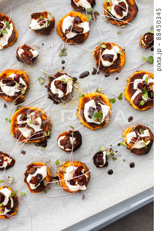 Sweet orange yam wedges with yogurt and dates Sweet orange yam wedges with yogurt and dates 88450345