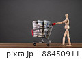 A man carries a cart from a supermarket with money 88450911