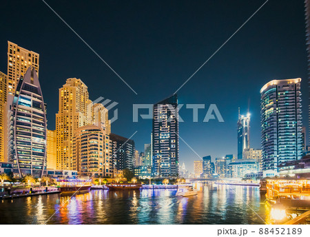 Night view of skyscraper of residential district in Dubai Marina And Tourist Boat, Sightseeing Boat Sailing On Dubai Marina Night view of skyscraper of residential district in Dubai Marina And Tourist Boat, Sightseeing Boat Sailing On Dubai Marina 88452189