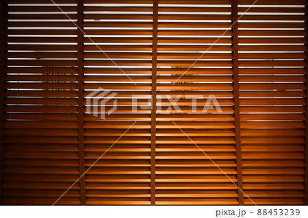 open wooden venetian blinds. lighting range control sunlight coming from a window. decoration interior. Modern jalousie. open wooden venetian blinds. lighting range control sunlight coming from a window. decoration interior. Modern jalousie. 88453239